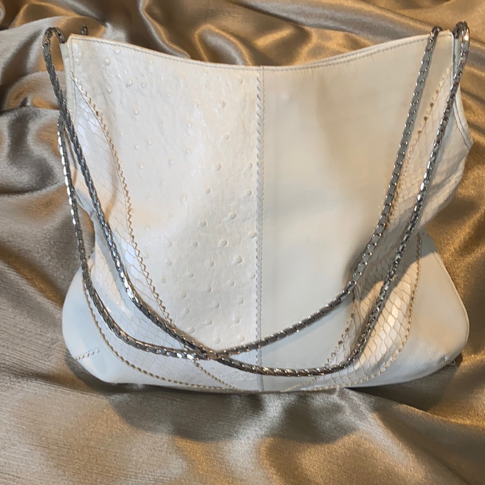 Cream colored Versace purse with silver strap